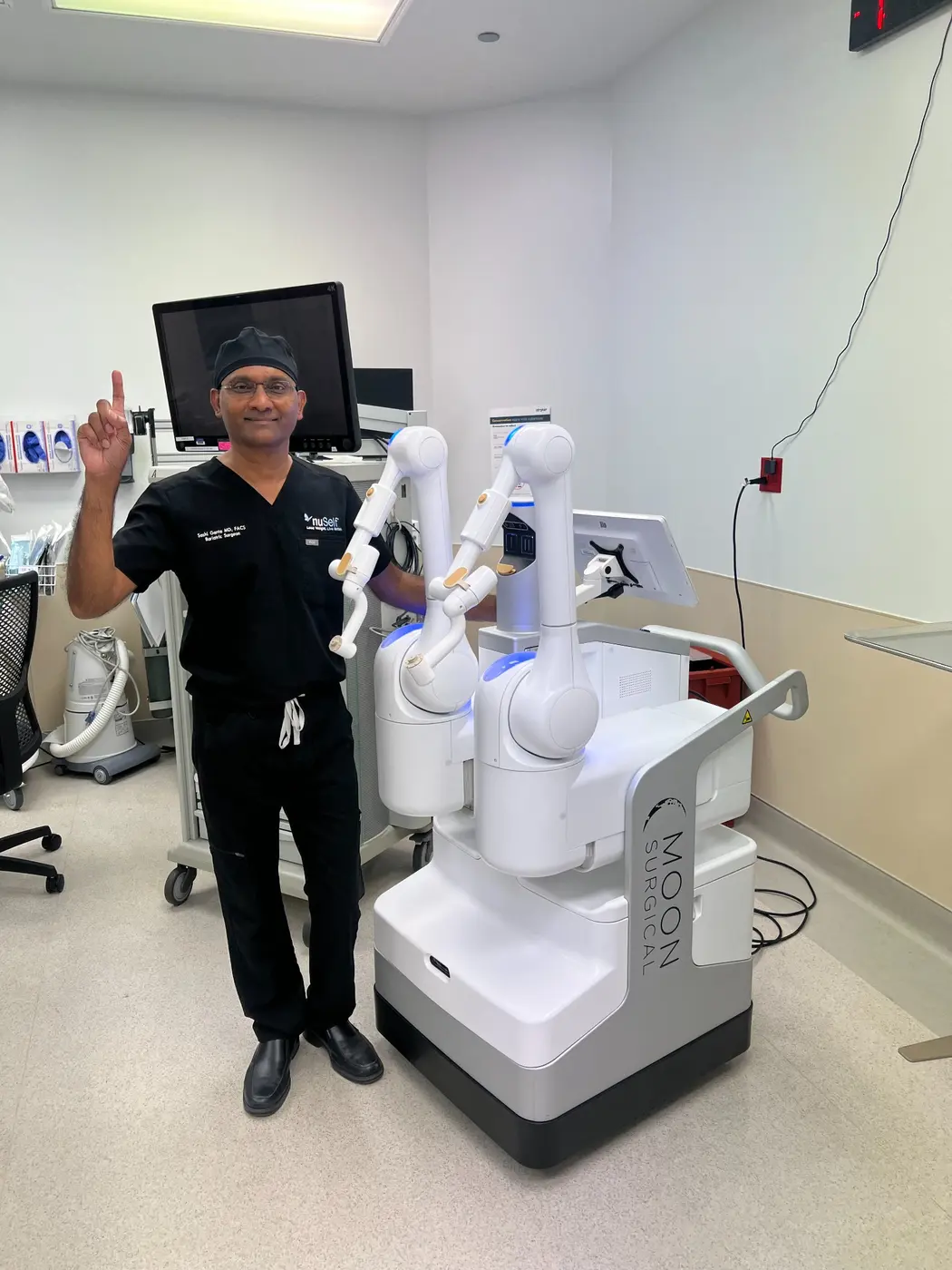 Dr. Sashidhar Ganta with a compact robotic surgical platform